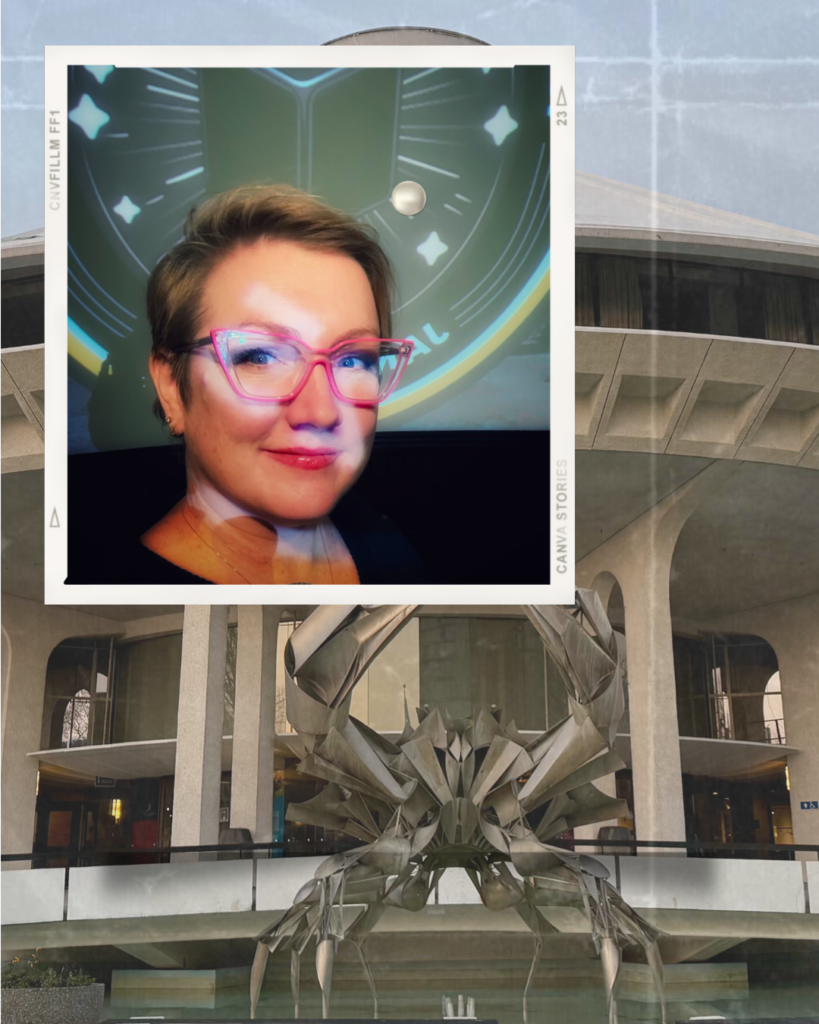  digital collage featuring a close-up portrait of a woman with short hair, pink-framed glasses, and a confident smile, overlaid on a background of a futuristic or sci-fi-inspired setting. The inset portrait has a Polaroid-style border and a reflection effect, adding depth. The larger background showcases a modern, curved architectural structure with a striking metallic sculpture of a geometric crab-like creature in front. The composition gives a layered, artistic feel, blending personal photography with architectural and sci-fi elements.